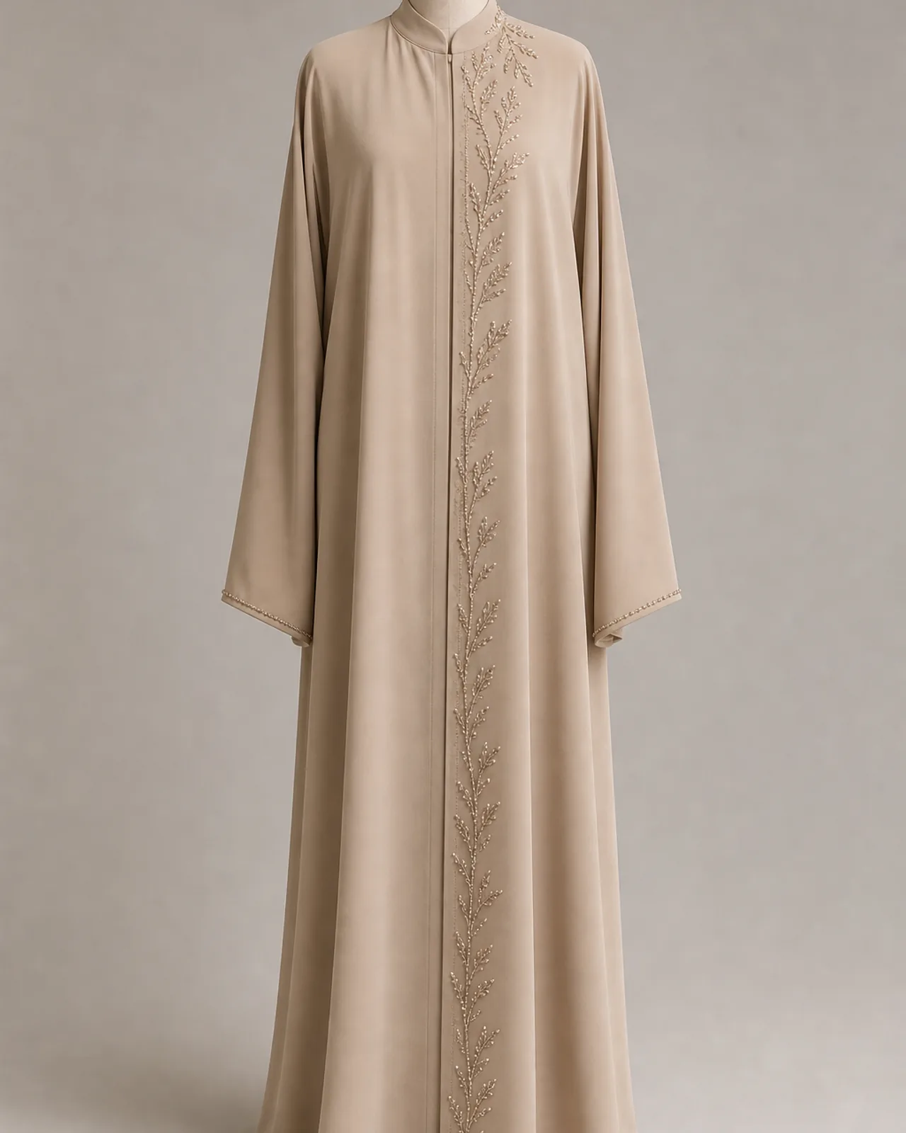 Front view, full length, beaded abaya worn closed, showing overall beading placement and how the decorated panel falls