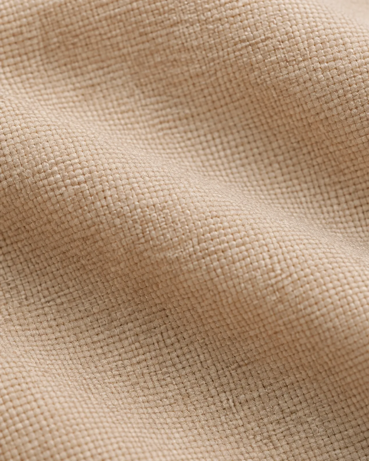 Crepe fabric close-up at roughly three times magnification, showing the grain and matte surface