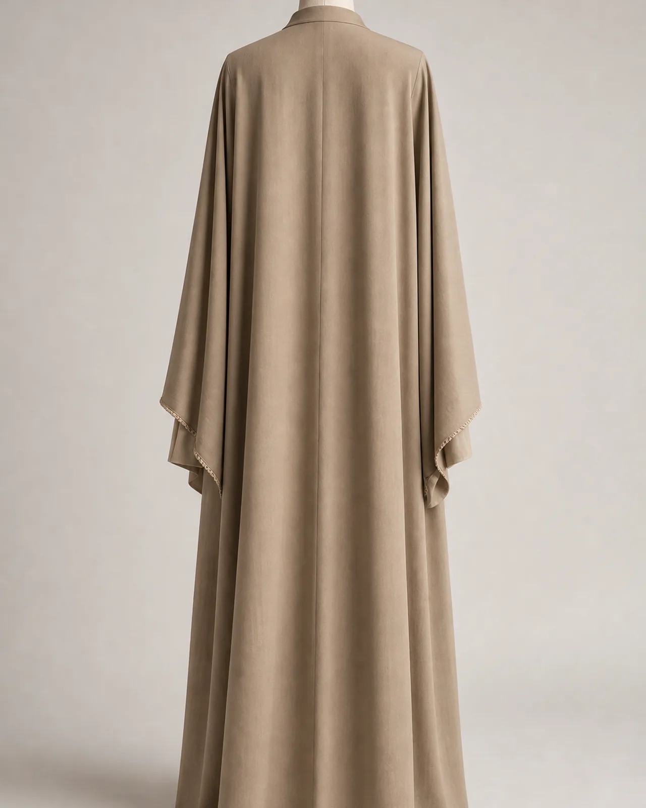 Back view, full length, showing the drop of the wide sleeve and the back panel of the garment