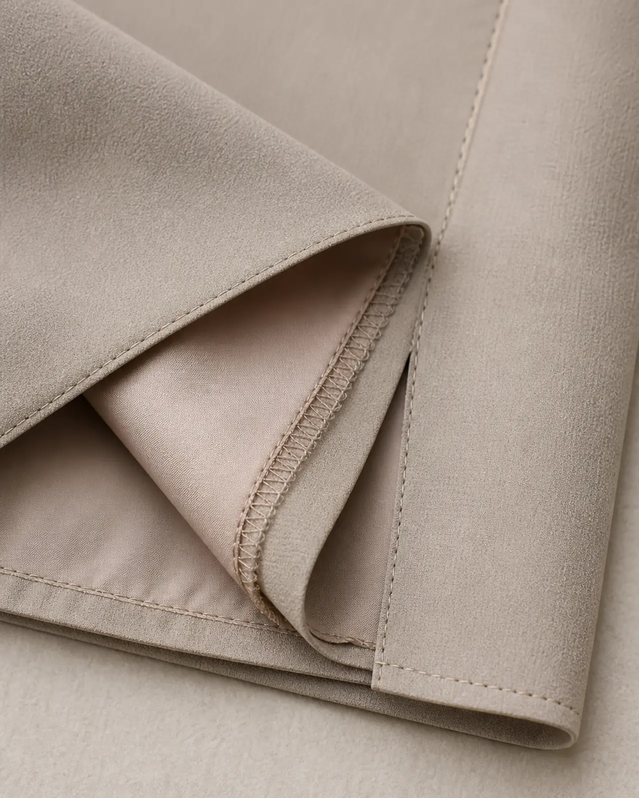 Inside view of the hem and side seam showing lining, seam finish and hem allowance on a premium garment