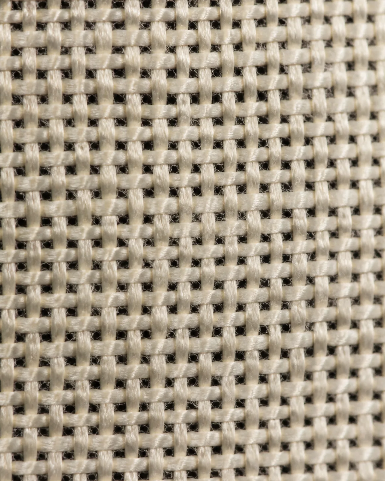 Fabric close-up at roughly three times magnification showing the modal surface and its opacity when held over a dark layer