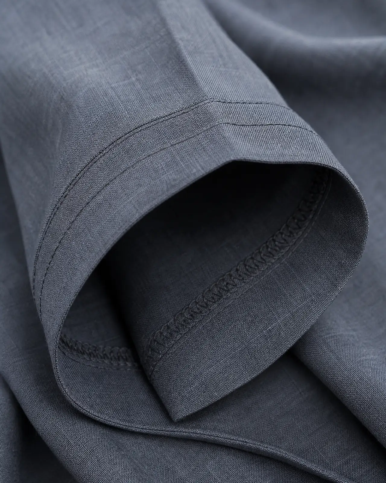 Sleeve cuff close-up showing hem allowance, cuff depth and edge stitching from the inside
